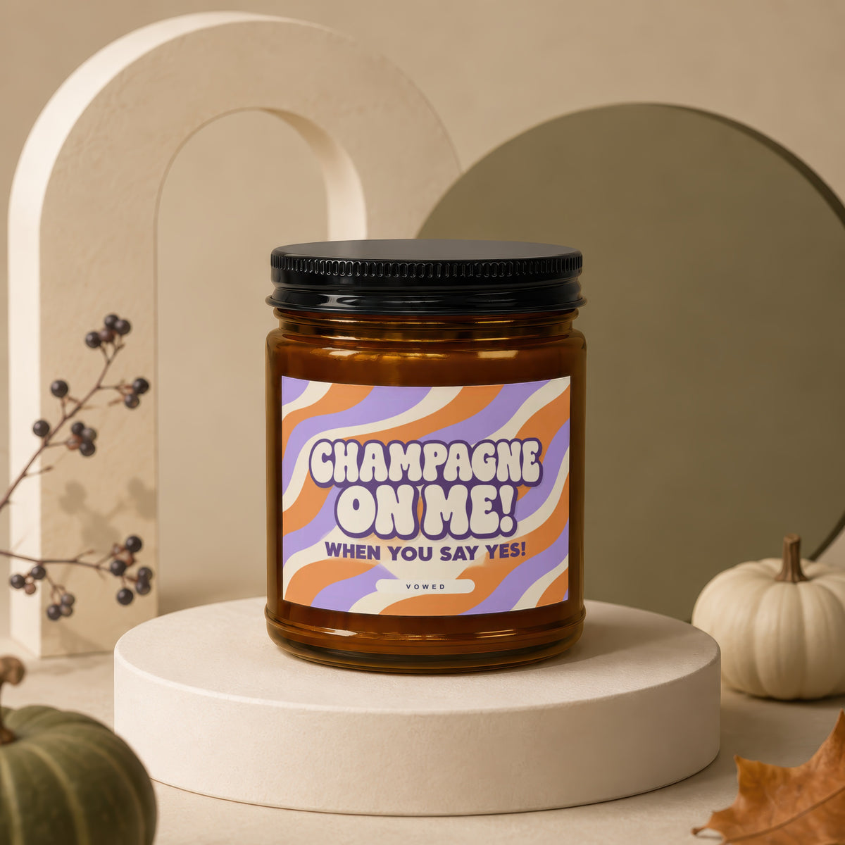 Amber glass candle with "Champagne On Me! When You Say Yes!" label.