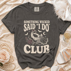 Dark grey t-shirt with "Something Wicked Said I Do Club" text and skeleton hand holding ring.
