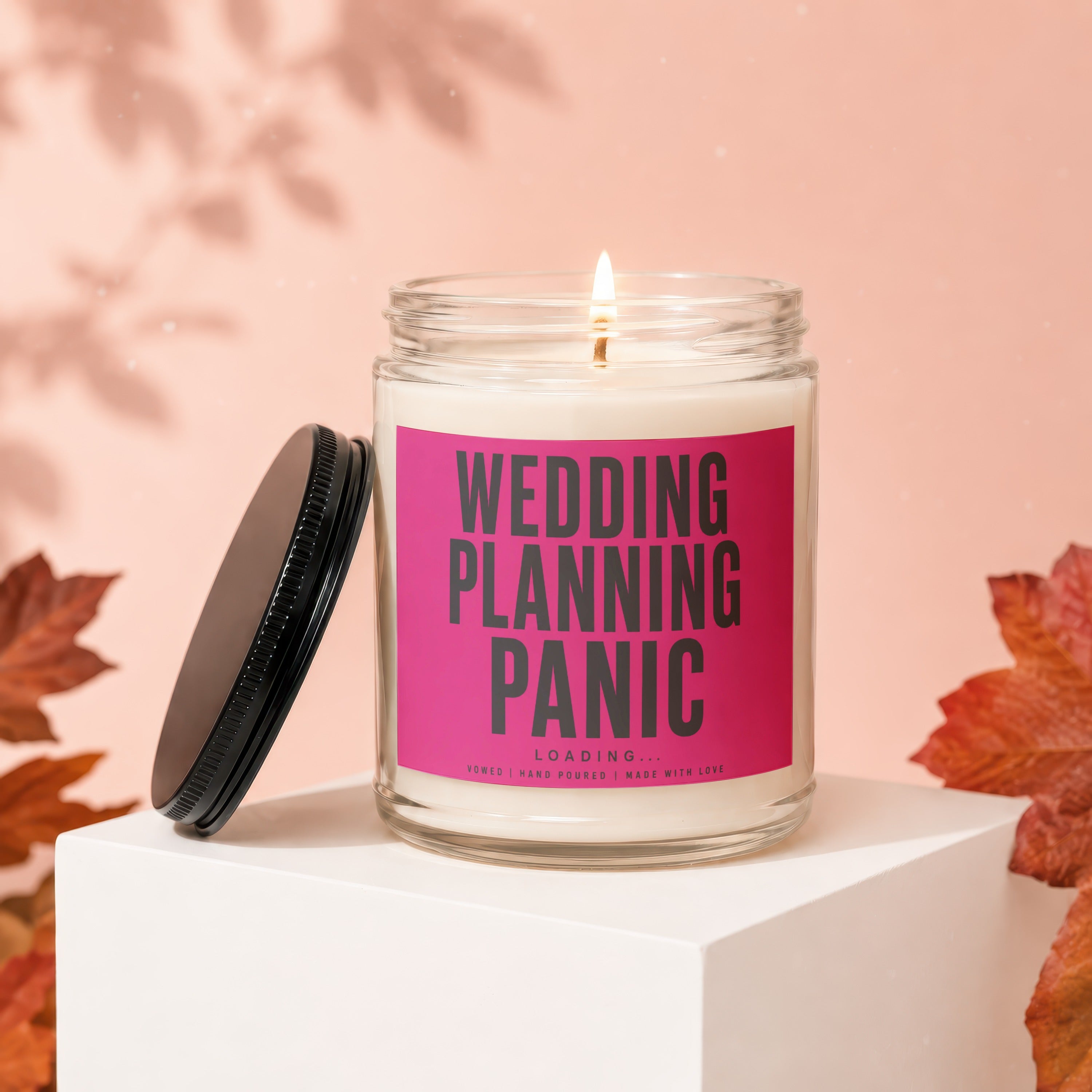 Jar candle with pink label reading "Wedding Planning Panic Loading...".