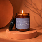 Amber glass candle with lit flame, reads "In Memory Of My Free Time".