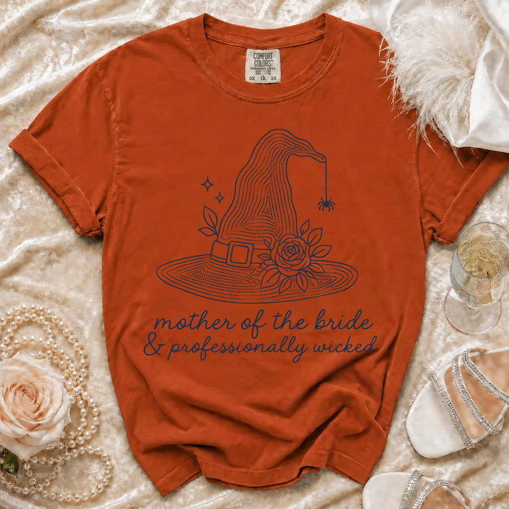 Orange t-shirt with "mother of the bride & professionally wicked" and witch hat graphic.