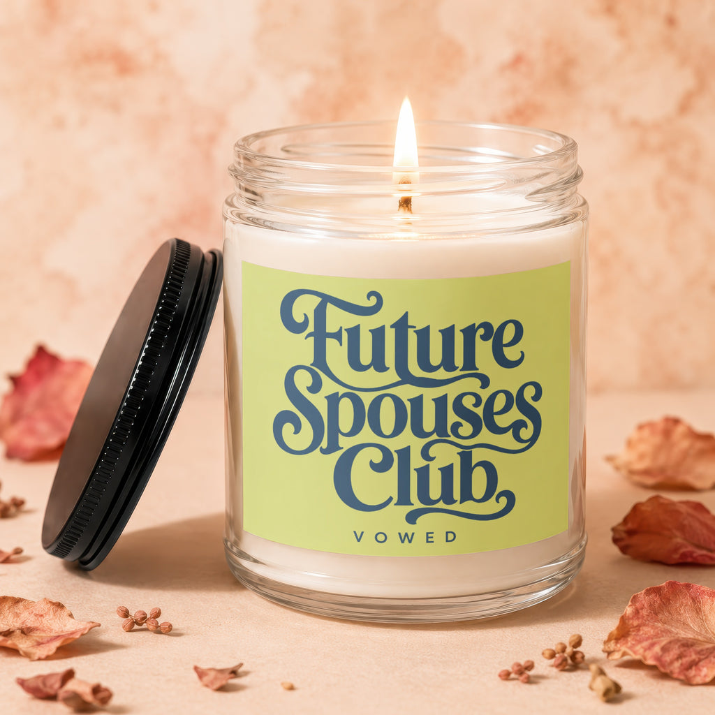 Lit candle in a glass jar with a green label reading "Future Spouses Club Vowed".