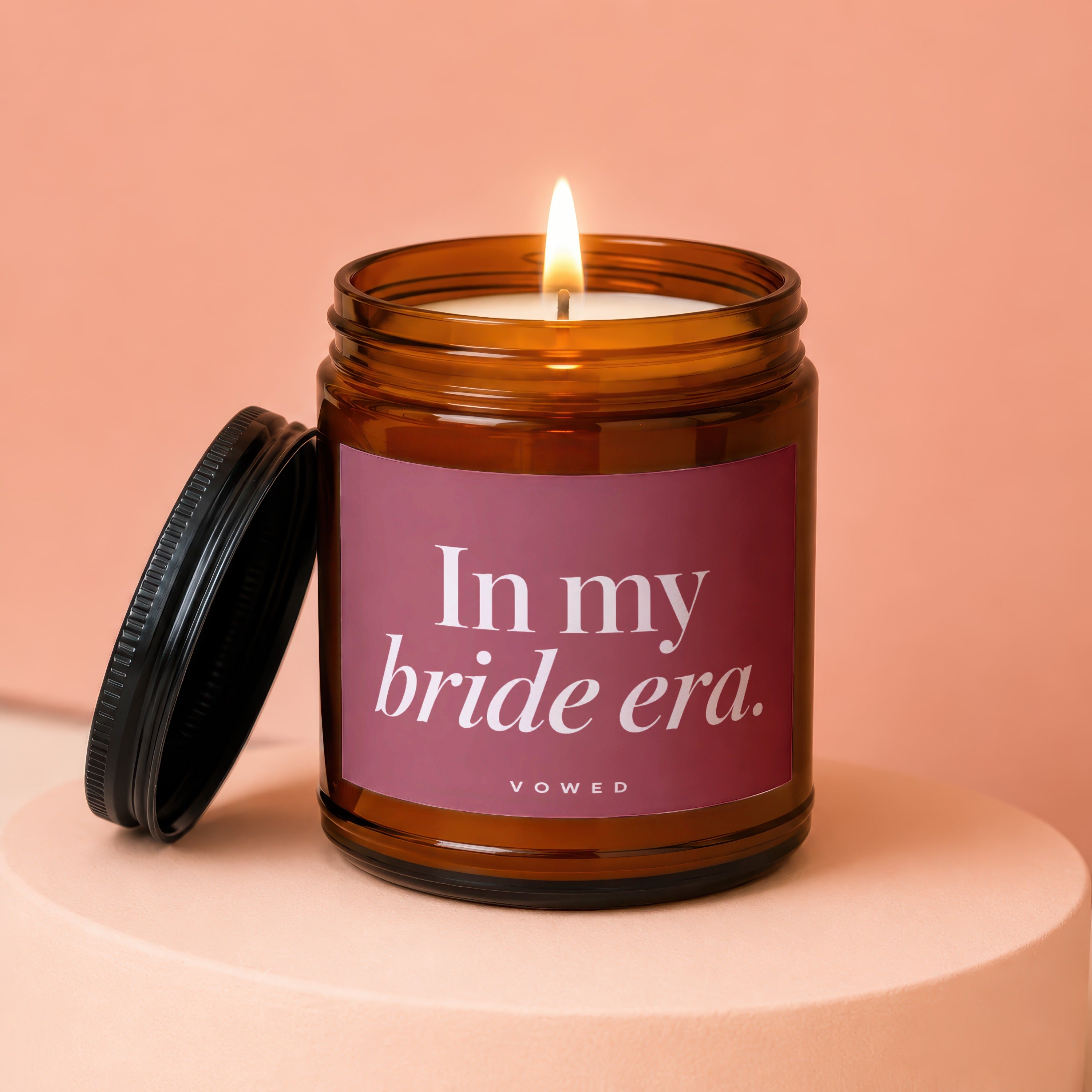 Amber jar candle with black lid, text "In my bride era." and "VOWED".