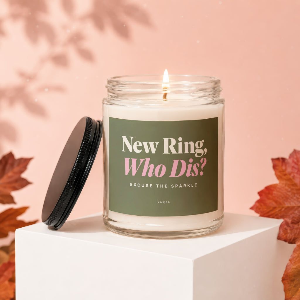 Glass candle with "New Ring, Who Dis? Excuse The Sparkle" text, lit wick.
