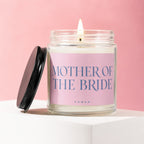 Candle labeled "Mother of the Bride" with lid ajar on a white pedestal.