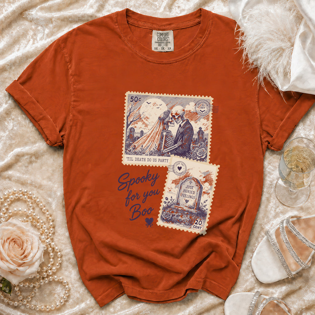 Orange t-shirt with skeleton couple and tombstone Halloween graphic.