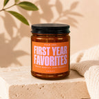 Amber jar with black lid labeled "Year One: First Year Favorites, Twelve Months. Zero Regrets."
