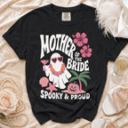 Black t-shirt with a white ghost graphic, "MOTHER OF THE BRIDE SPOOKY & PROUD" text.