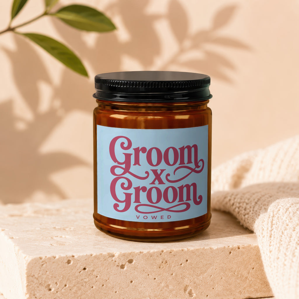 Candle with "Groom x Groom Vowed" text on a light blue label.