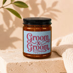 Candle with "Groom x Groom Vowed" text on a light blue label.