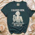 Teal t-shirt featuring a retro graphic of a smiling woman holding mistletoe and a drink, with the text I RAISED HIM, I'm just here for the eggnog, and MOTHER OF THE GROOM.