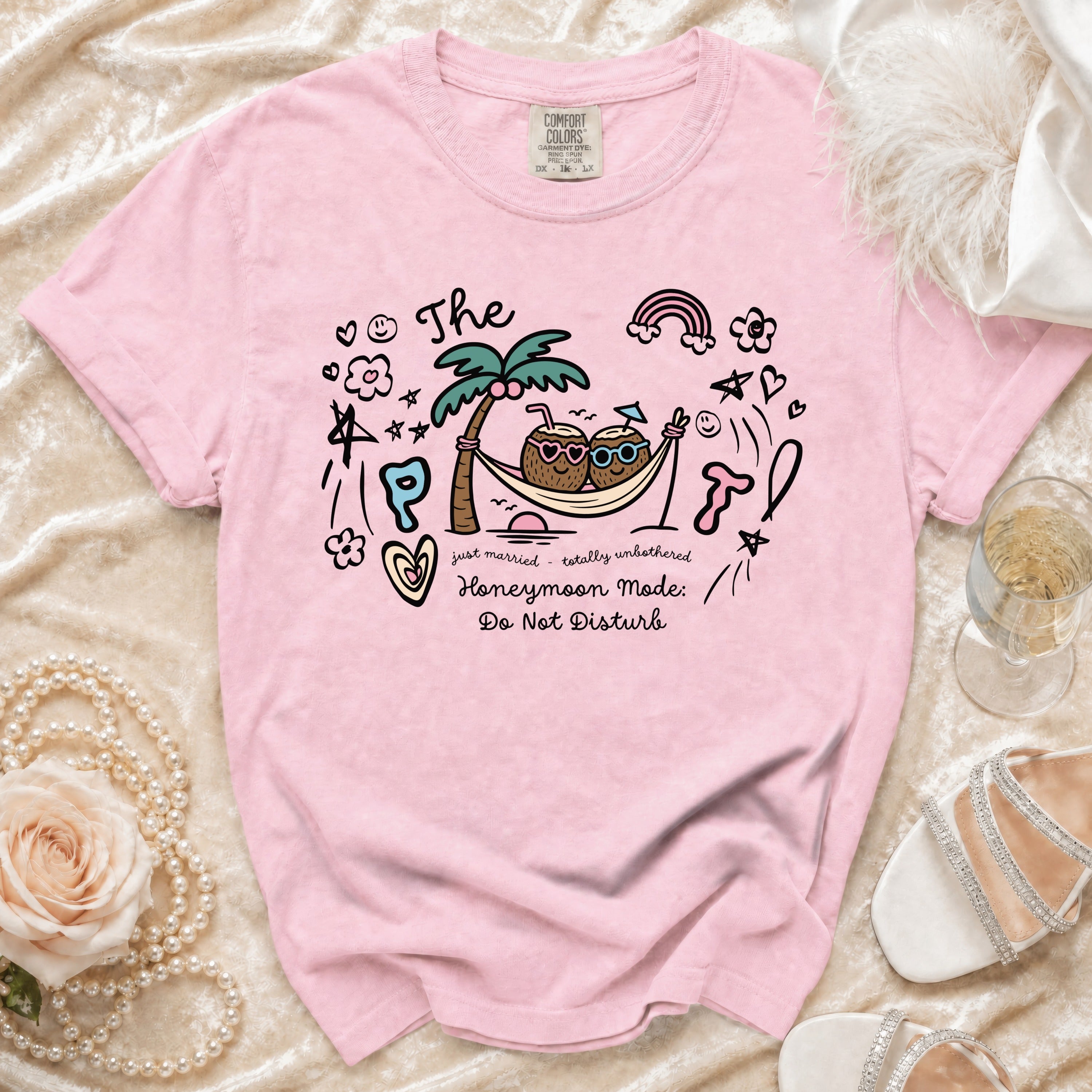 Pink t-shirt with "Honeymoon Mode: Do Not Disturb" text and tropical graphic.