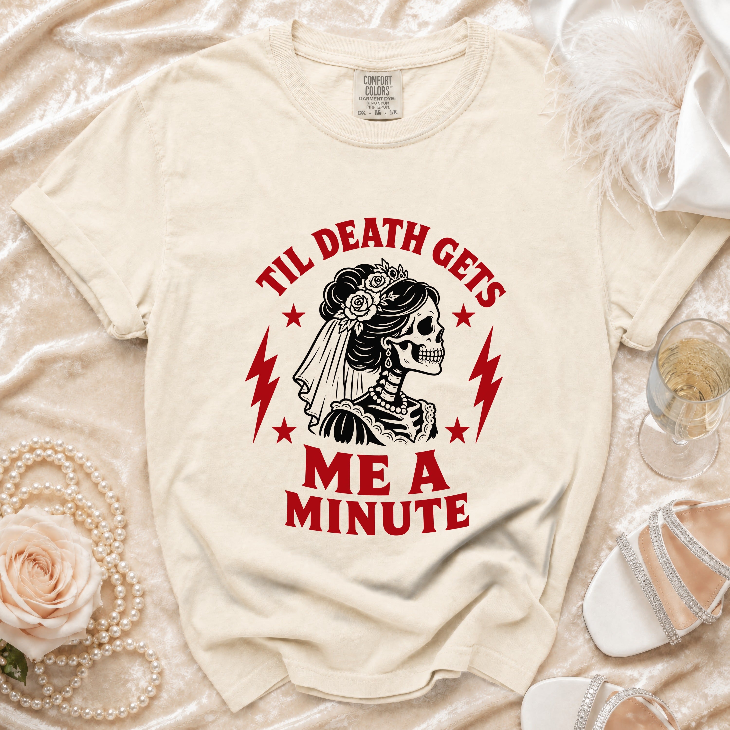Cream t-shirt with skeleton bride graphic and text "Til Death Gets Me A Minute".
