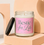 Candle with pink label reading "Bestie for Life" and "Vowed | Hand Poured."