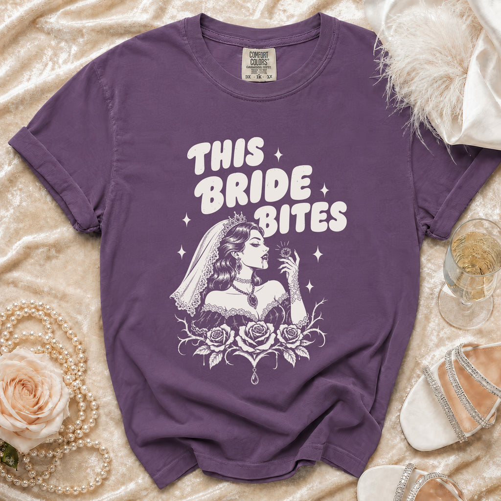 Purple t-shirt with "This Bride Bites" graphic, showing a bride and roses.