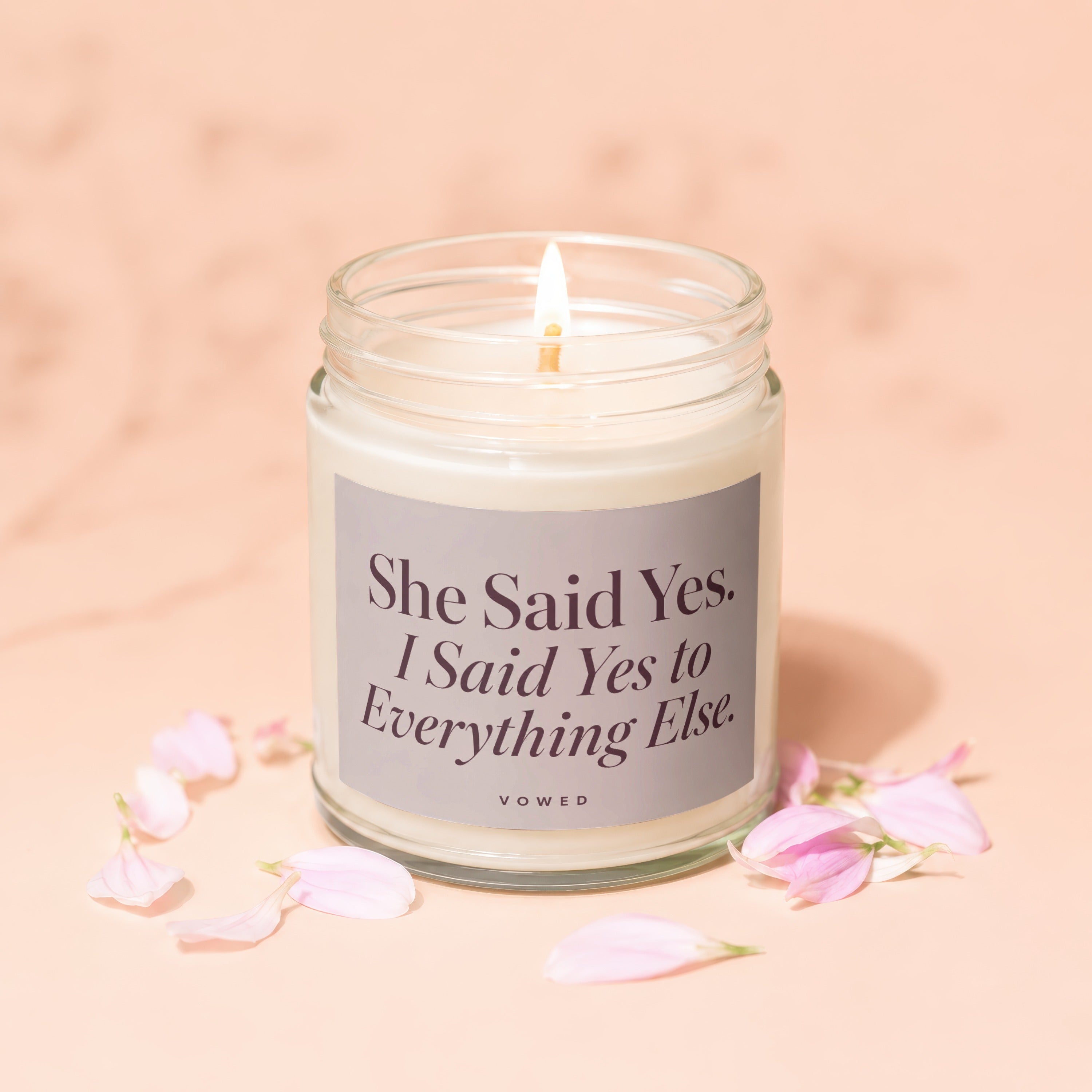 Candle with text "She Said Yes. I Said Yes to Everything Else. VOWED."