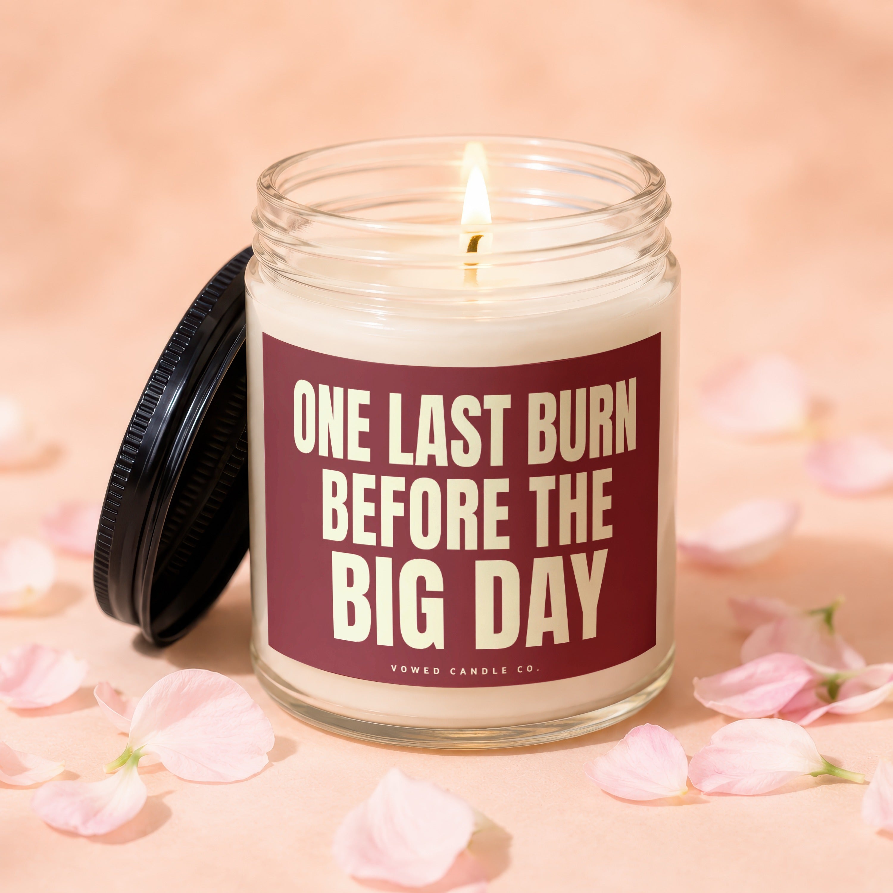 Candle with text "One Last Burn Before The Big Day" surrounded by pink petals.