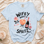 Light blue t-shirt with "Wifey Wants a Spritz" graphic featuring a drink and prosecco.