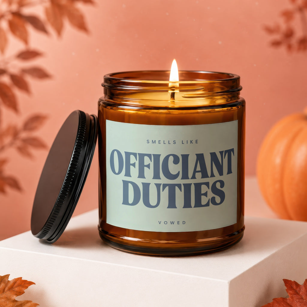 Brown glass candle with "OFFICIANT DUTIES" label and lit wick.