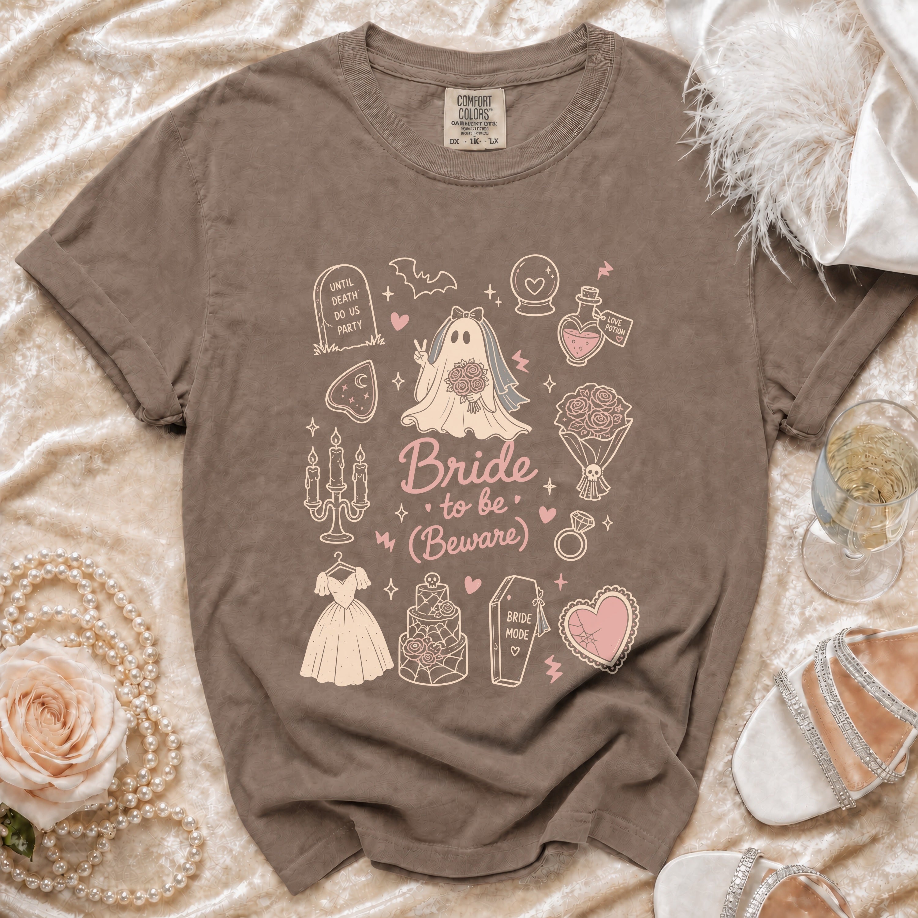 Brown Comfort Colors t-shirt with "Bride to be (Beware)" graphics and gothic bridal elements.