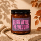 Amber candle in a jar labeled "Burn After The Wedding. Not Before. You Will Need It. Vowed."