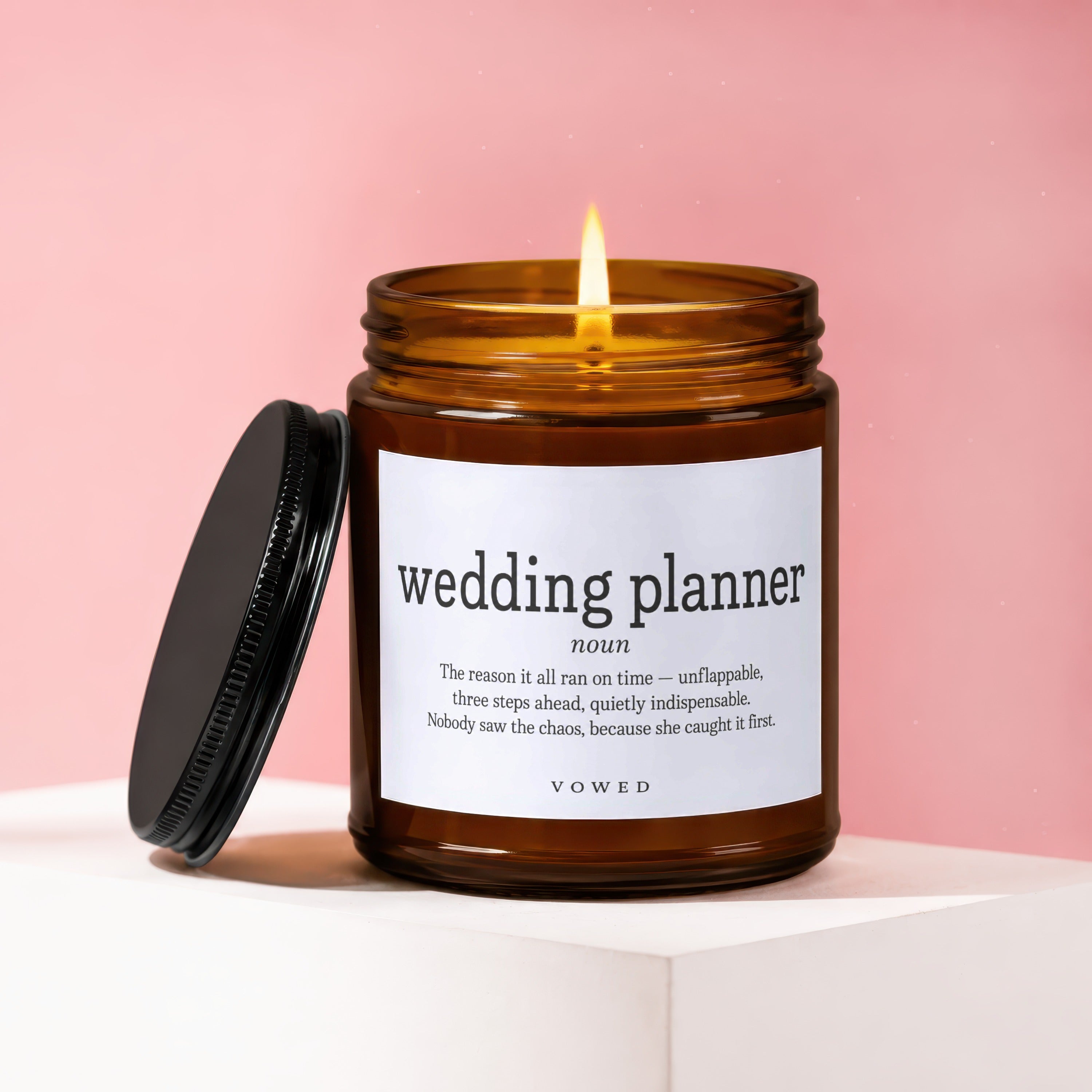 Amber candle with lit flame and "wedding planner noun" text.