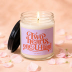 Lit candle with a label reading "Two hearts, one U-Haul" surrounded by pink petals.