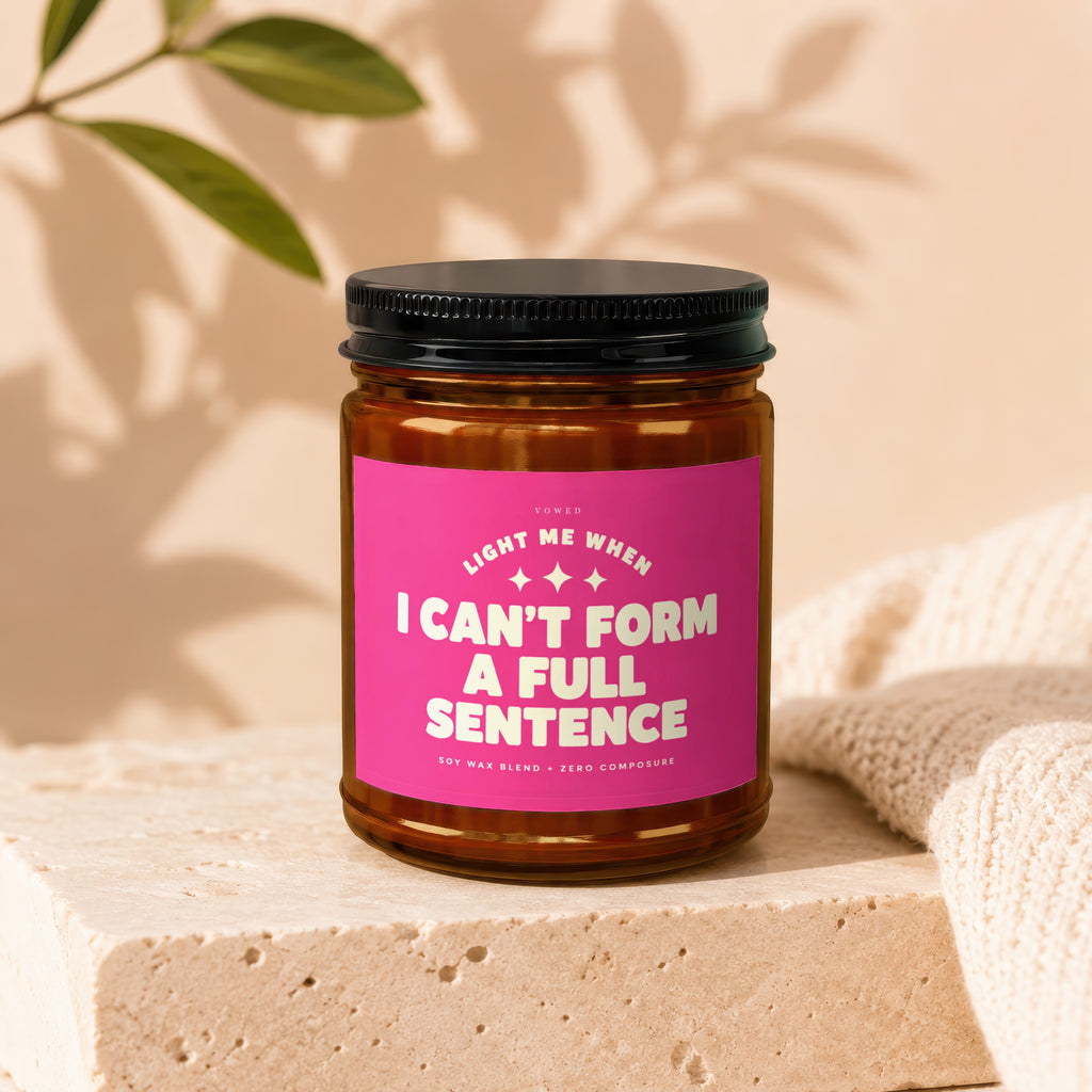 Soy wax candle with black lid, pink label reads "I Can't Form A Full Sentence".
