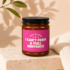 Soy wax candle with black lid, pink label reads "I Can't Form A Full Sentence".