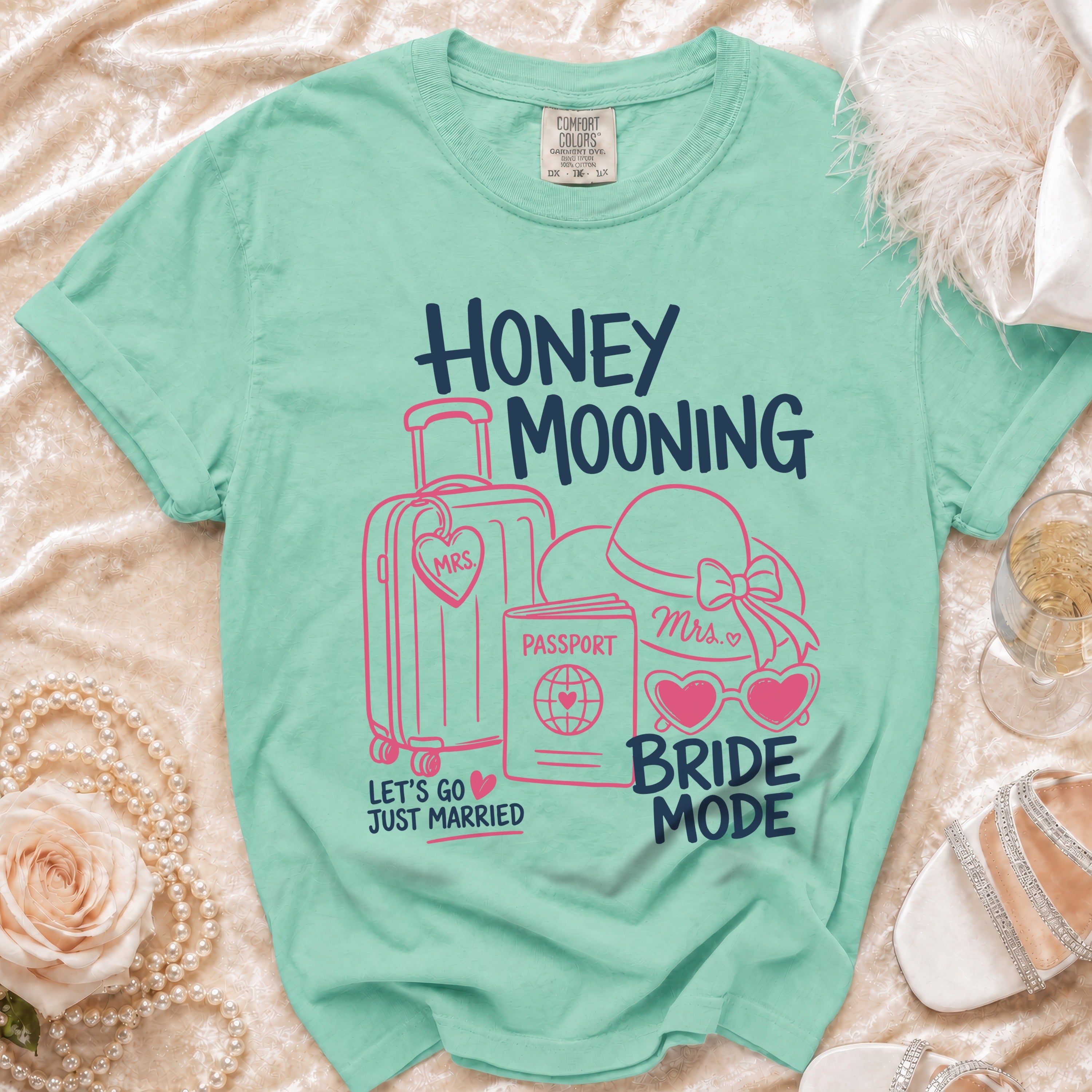 Aqua t-shirt with "Honey Mooning Bride Mode" text and travel icons.