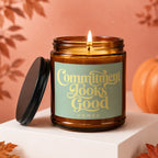 Amber glass candle burning, with lid off, featuring text Commitment Looks Good Vowed.