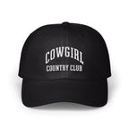 A black baseball cap with white embroidered text reading COWGIRL COUNTRY CLUB centered on the front panels.