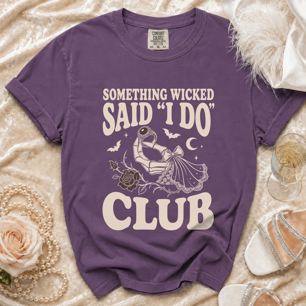 Purple t-shirt with text "SOMETHING WICKED SAID 'I DO' CLUB" and skeleton hand graphic.