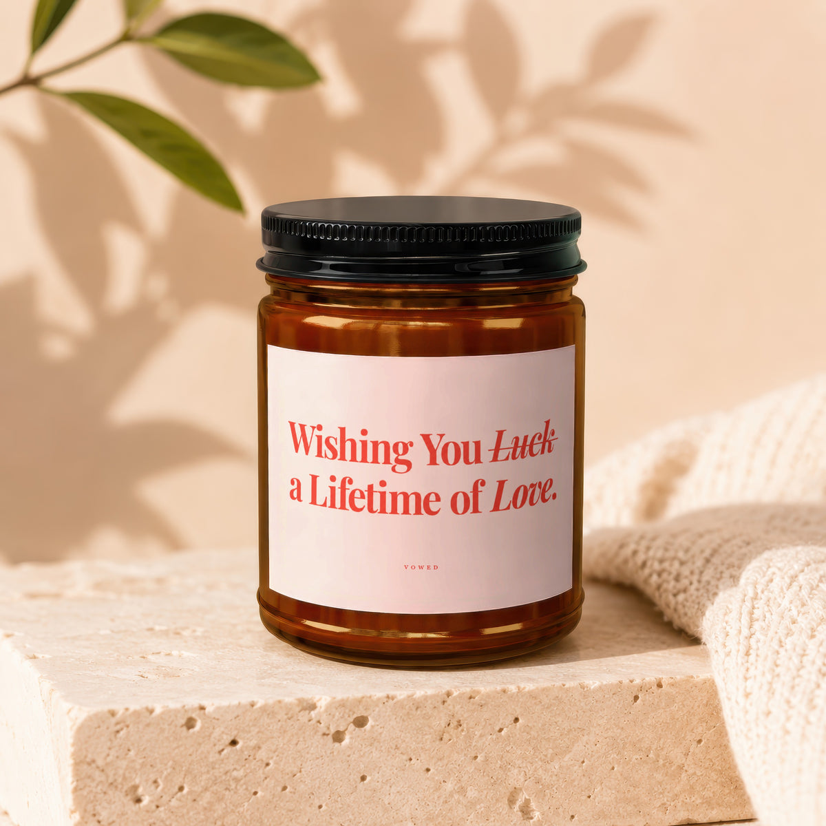 Amber jar candle with black lid, label reads "Wishing You Luck a Lifetime of Love."