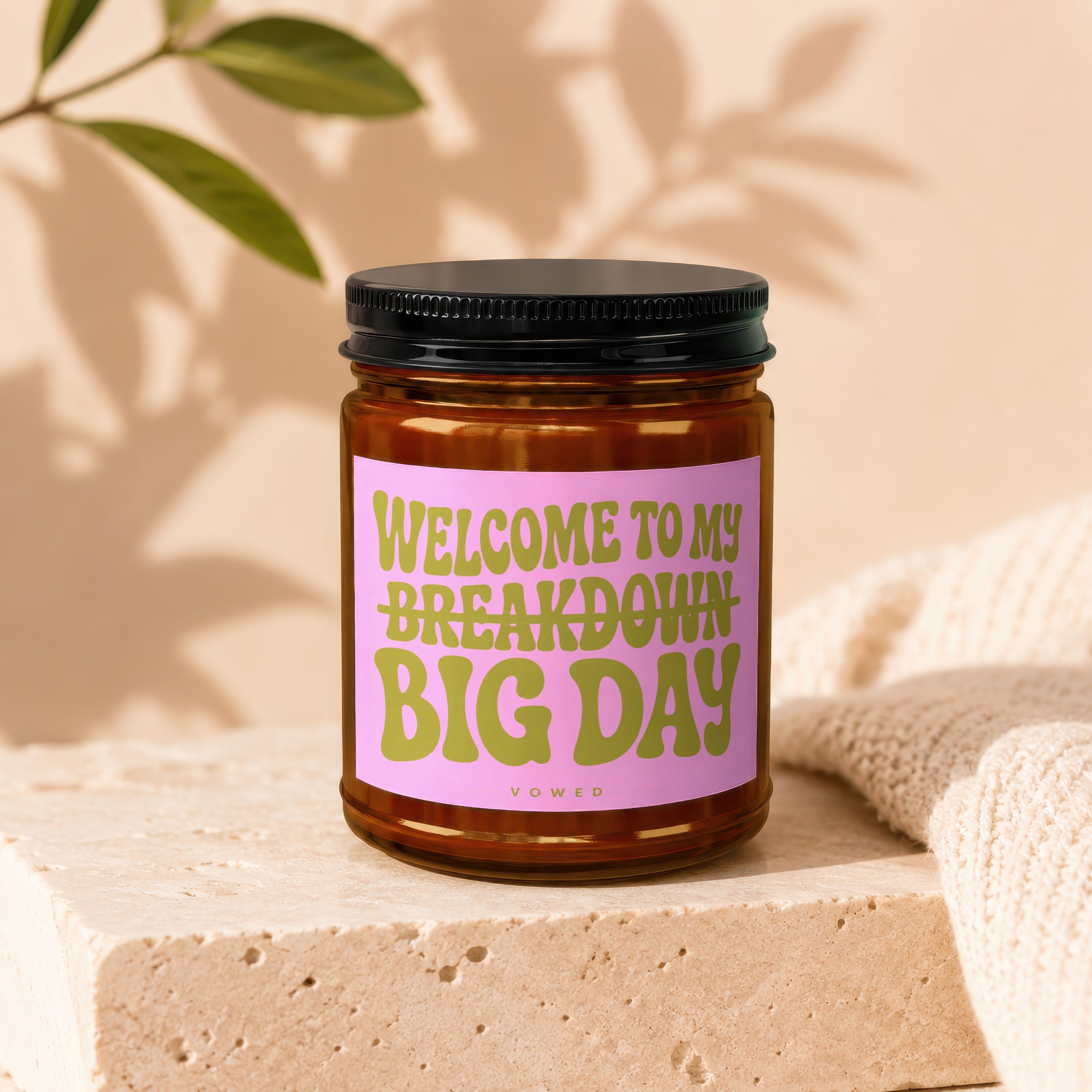 Amber candle with black lid and pink label that reads "Welcome to my breakdown big day".