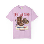 Pink t-shirt graphic with cowboy boots, hat, and "Her Last Rodeo" text.