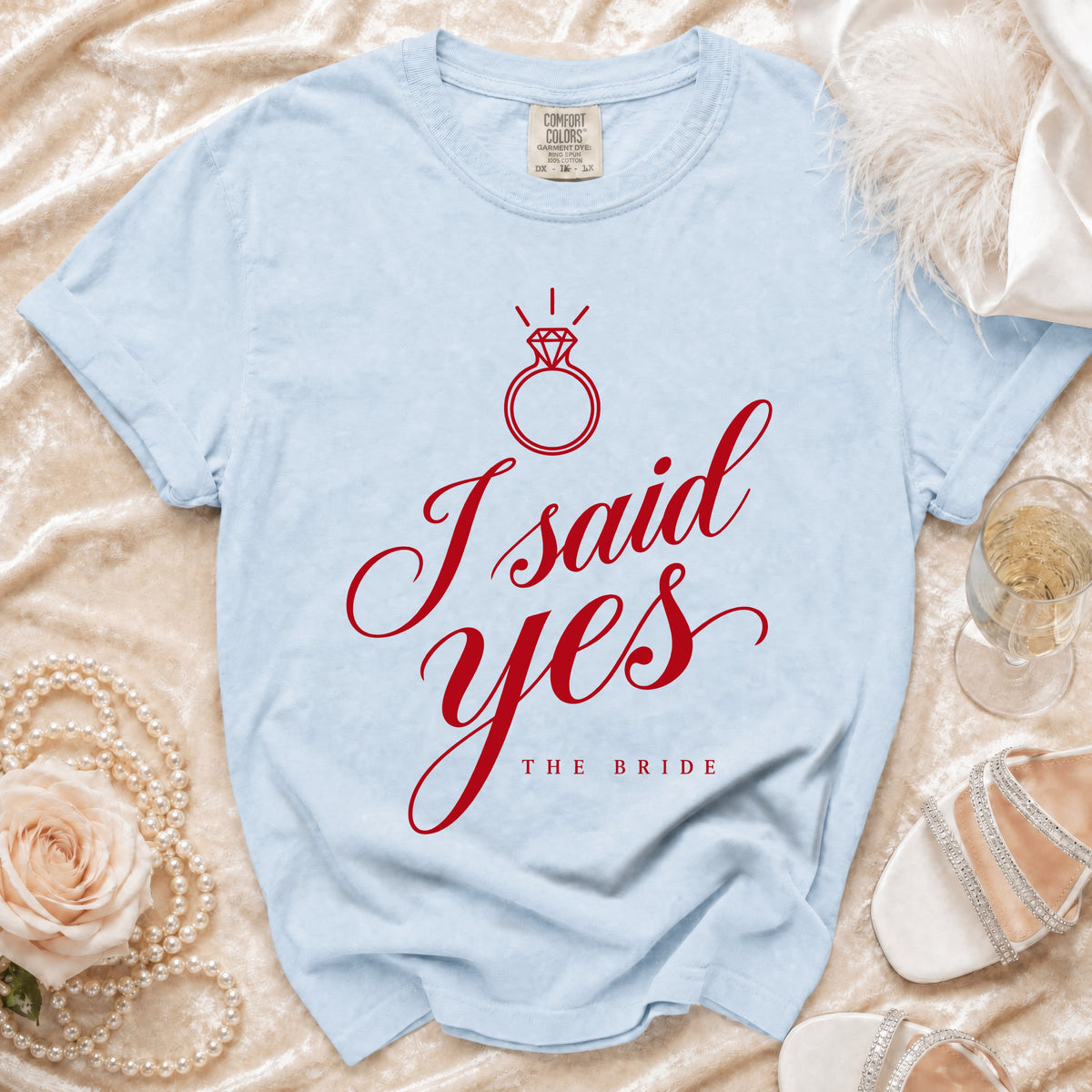Light blue t-shirt with red "I said yes" and "The Bride" text, featuring a diamond ring graphic.