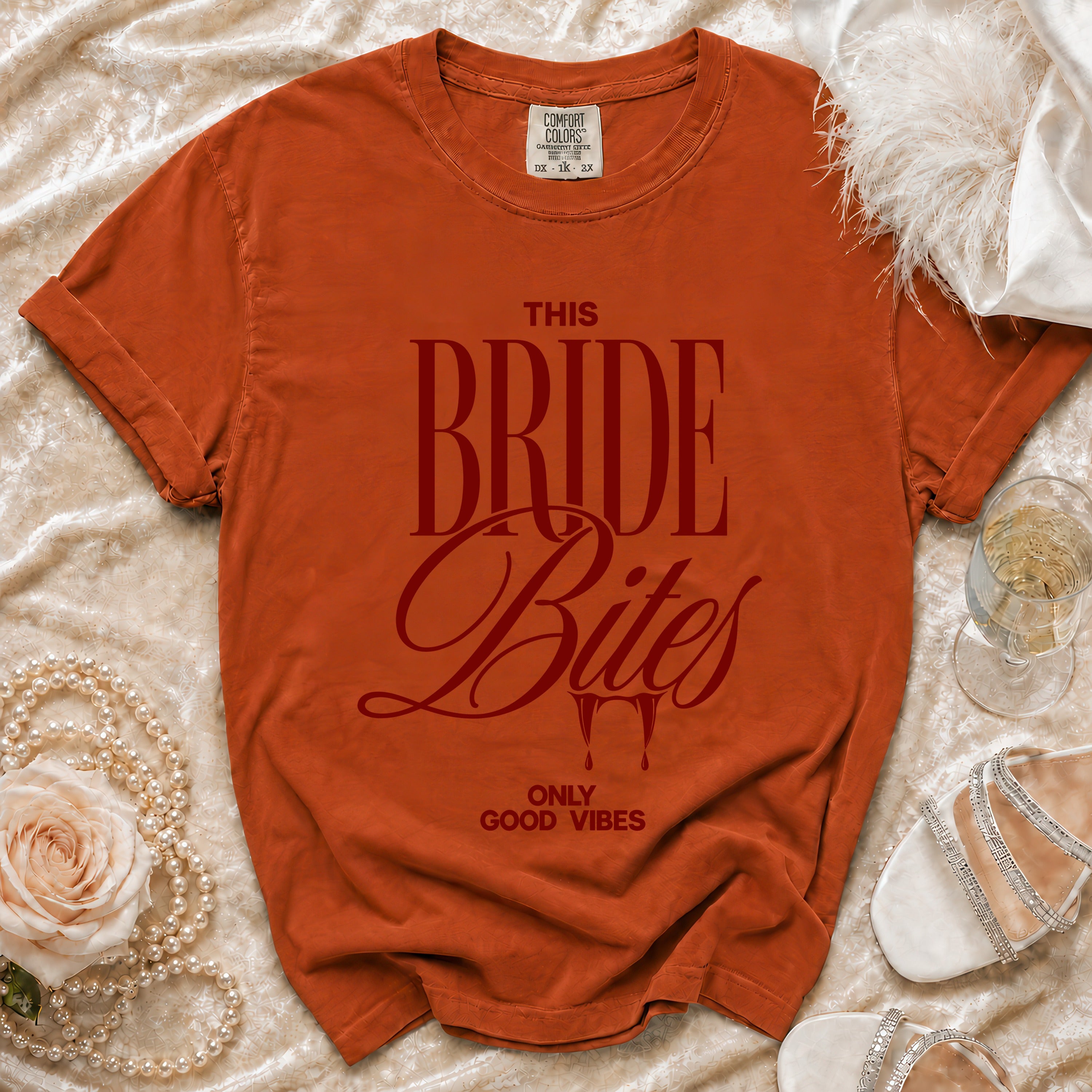Orange t-shirt with "This Bride Bites Only Good Vibes" text and vampire fangs.