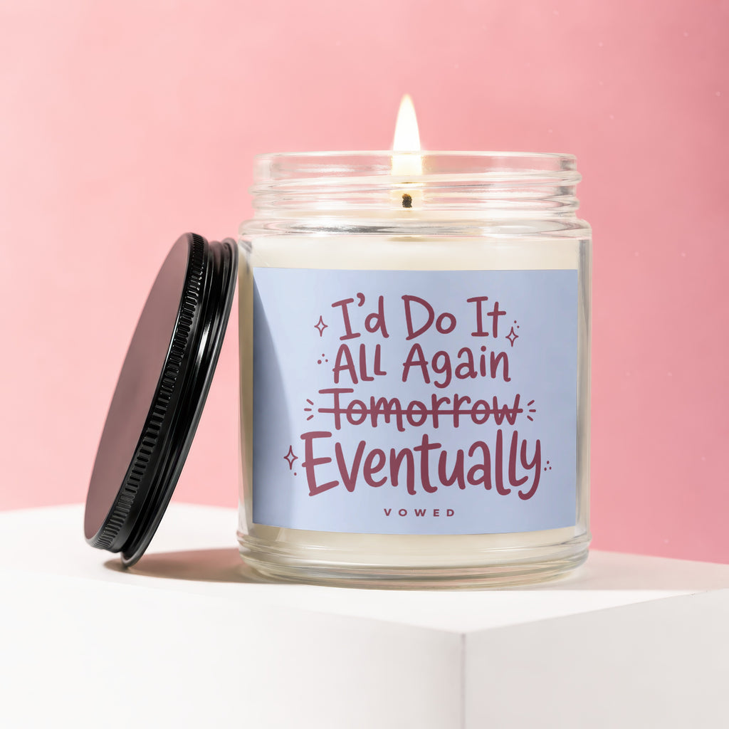 Candle with text "I'd Do It All Again Tomorrow Eventually" on a blue label.