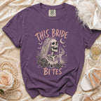 Purple t-shirt with skeleton bride graphic reading "This Bride Bites."