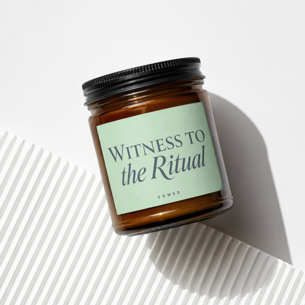 Amber jar candle with black lid, reads "WITNESS TO the Ritual" and "VOWED".