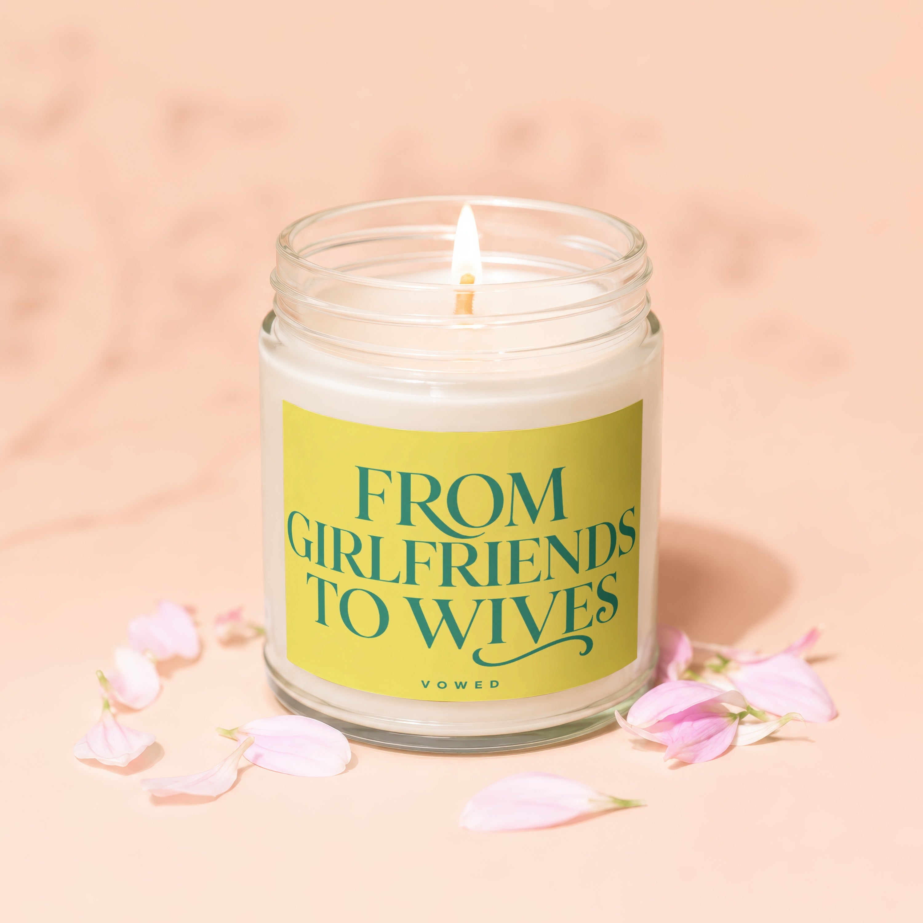 Glass jar candle with yellow label reading "From Girlfriends To Wives"