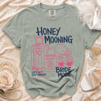 Grey t-shirt with "HONEY MOONING" and "BRIDE MODE" text and graphics.