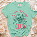 "Mother of the Bride Club" graphic on a mint green t-shirt with wedding accessories.