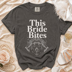 Dark grey t-shirt with "This Bride Bites" text and vampire fangs illustration.