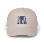 Beige baseball cap featuring embroidered dark blue text that reads BOOTS & BLING on the front.