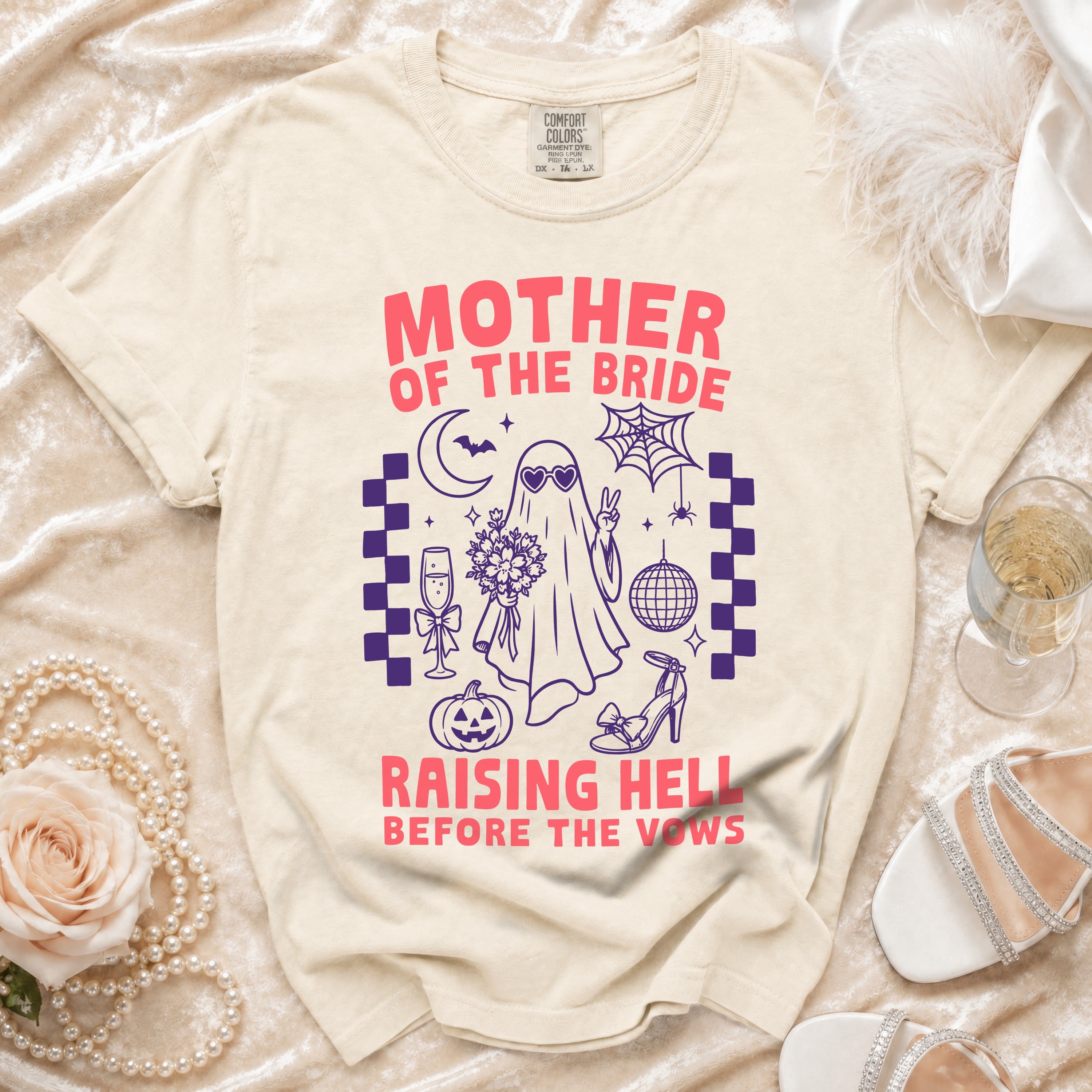Cream t-shirt with "Mother of the Bride Raising Hell Before the Vows" graphic.