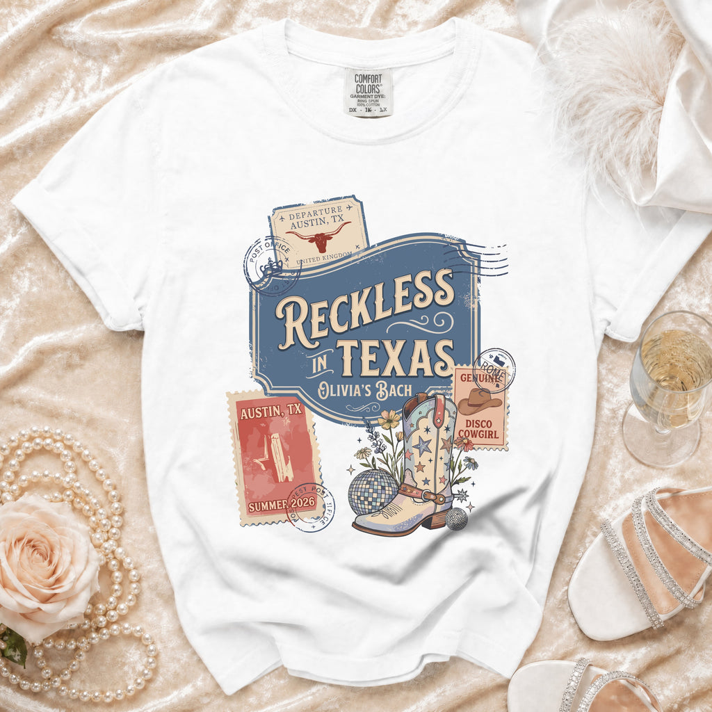 White t-shirt with "Reckless in Texas" and disco cowboy boot graphic.