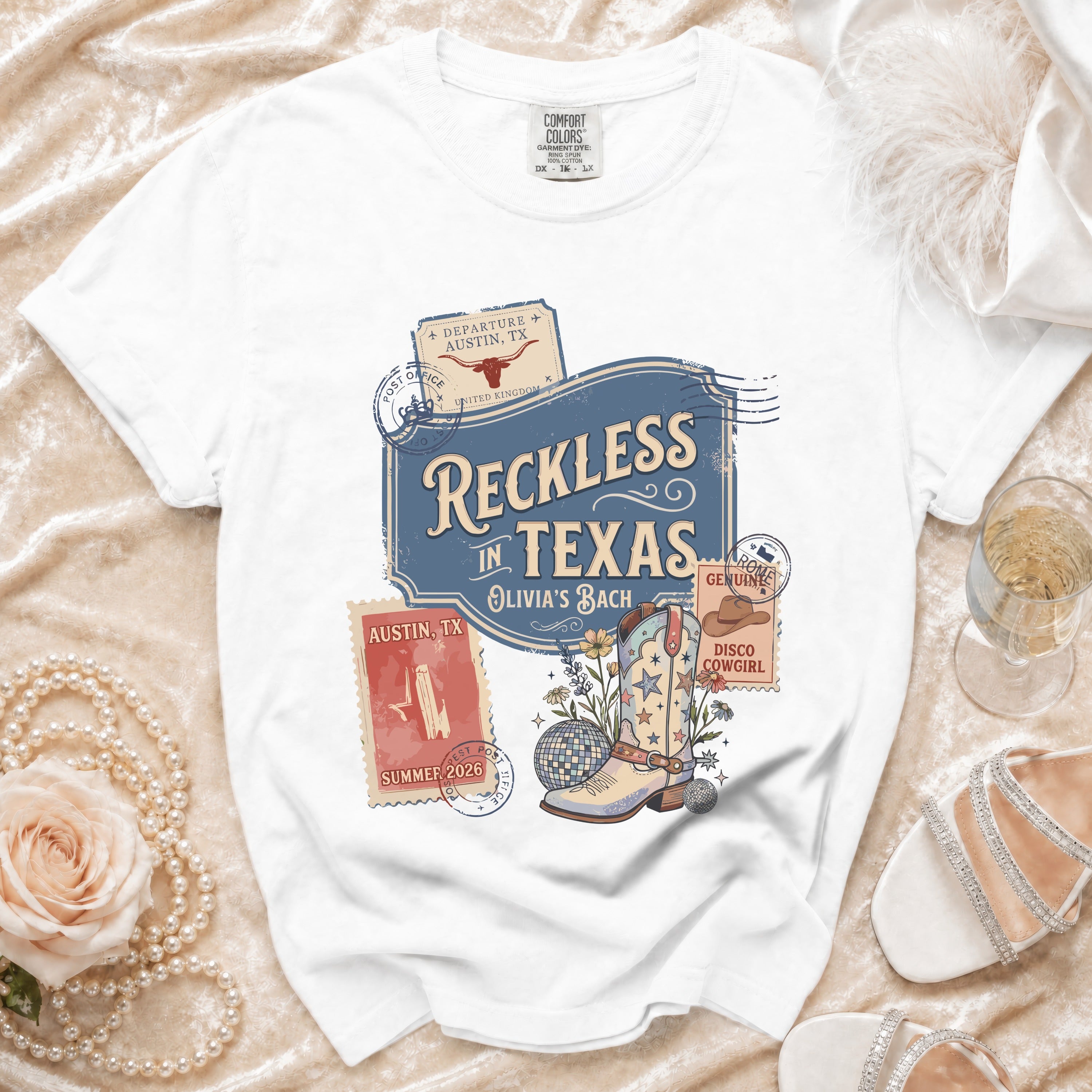 White t-shirt with "Reckless in Texas" and disco cowboy boot graphic.