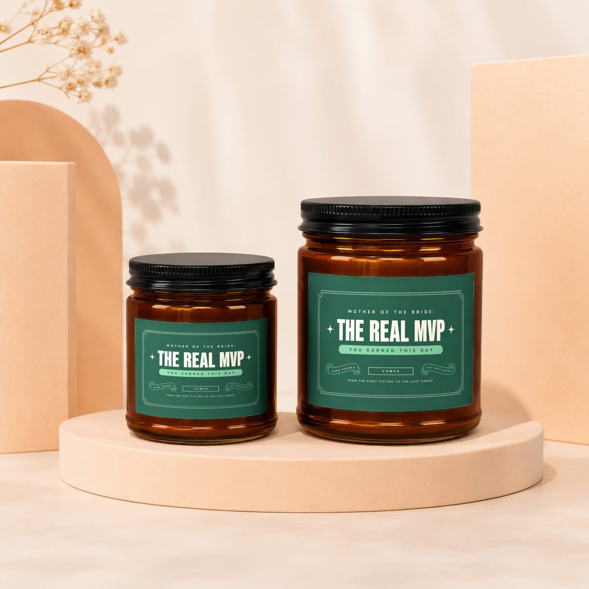 Two amber glass candles with "The Real MVP" text on green labels.